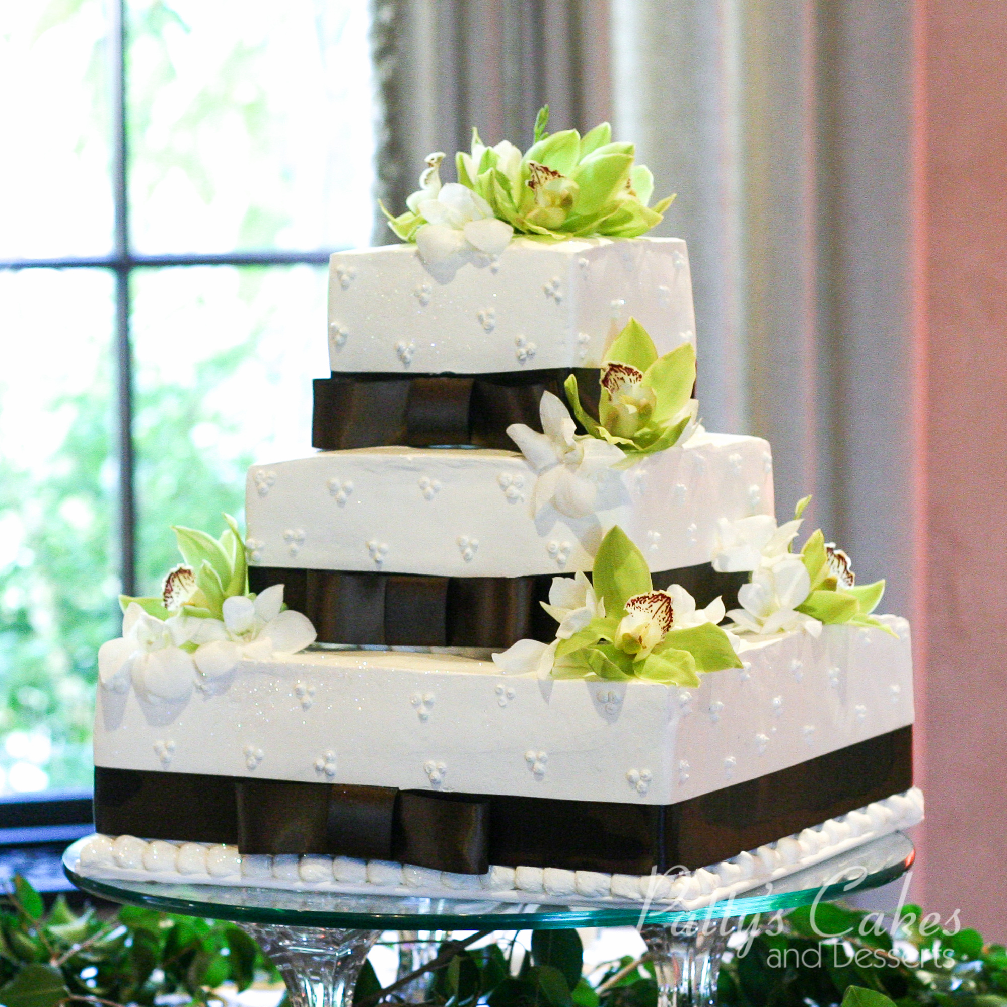 square-wedding-cake-brown-ribbon-green-flowers