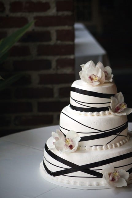 black ribbon wedding cake with flowers