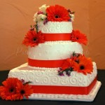 wedding cake orange ribbon flowers square round