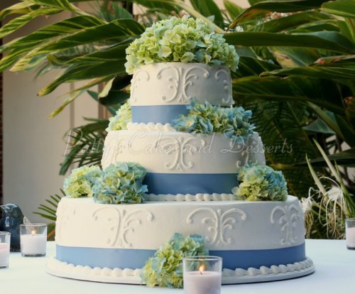 Square wedding cakes with ribbon and flowers