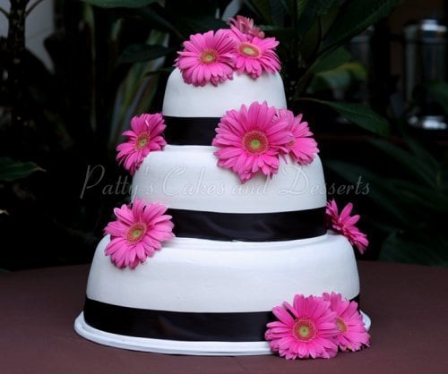 wedding cake white pink gerber daisey black ribbon round