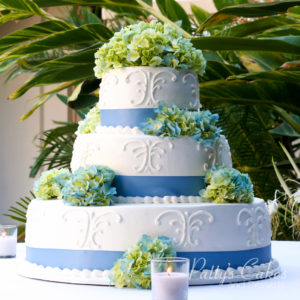 wedding cake blue ribbon white green flowers