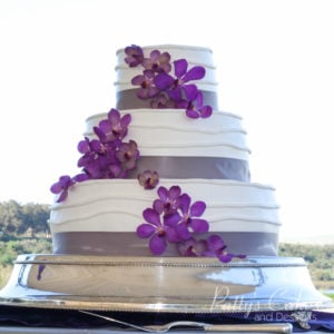 wedding cake stand purple flowers outdoors